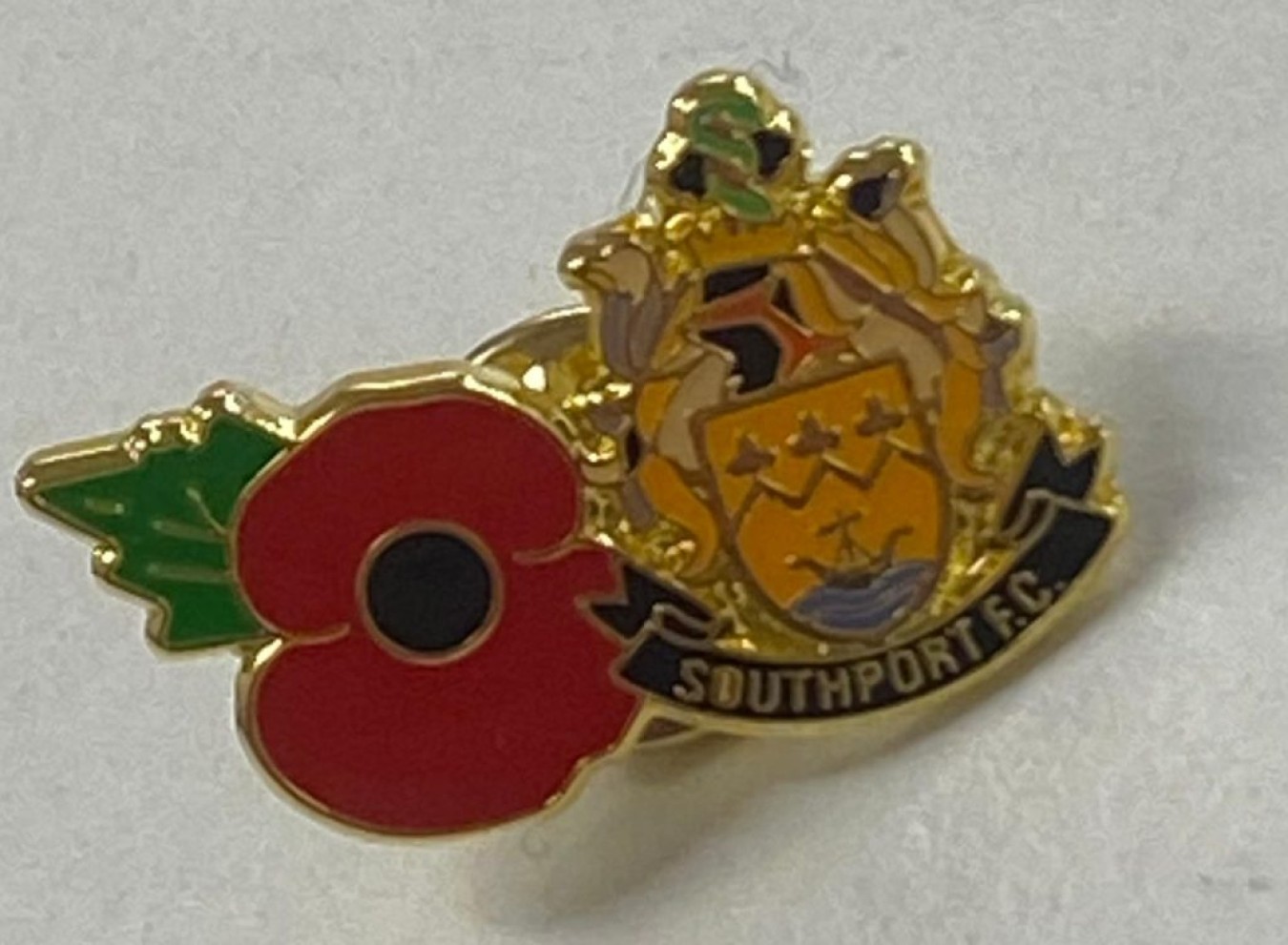 Southport FC crest pin with red poppy motif overlapping the shield