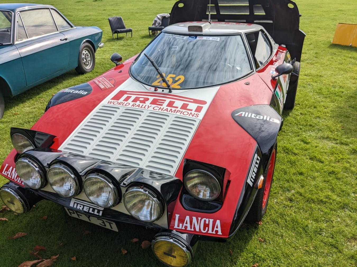 a red car parked on grass