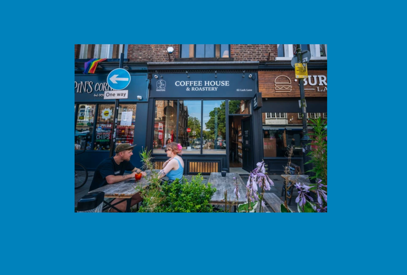 Outdoor café seating in front of a coffee house on a city street