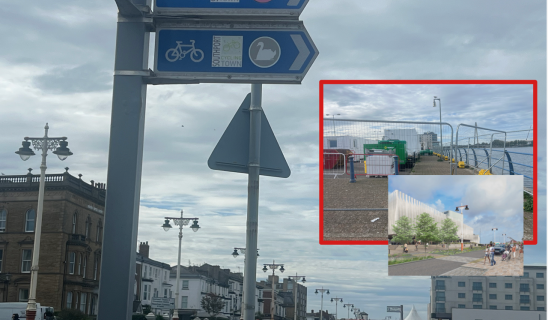 Seaside promenade with signposts and a red-framed collage of construction and modern buildings by the water.