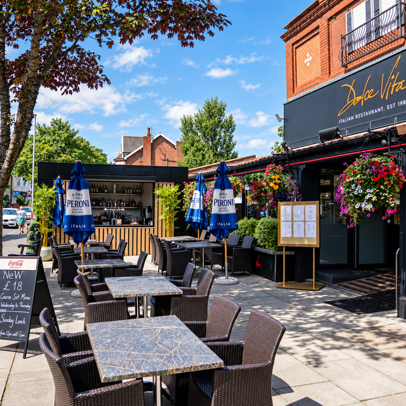 Curbside Italian restaurant with outdoor seating and blue Peroni umbrellas