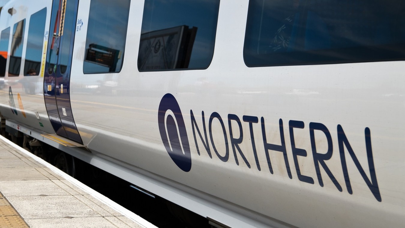 Northern train at platform, close view of carriage with blue logo and windows