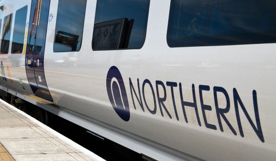 Northern train at platform, close view of carriage with blue logo and windows