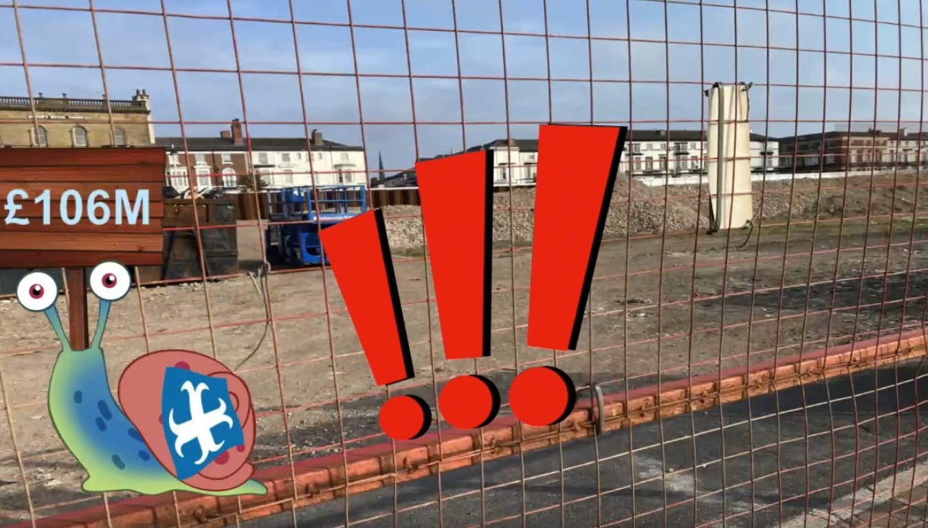 Cartoon snail with blue shell and red exclamation marks over a construction site behind a wire fence