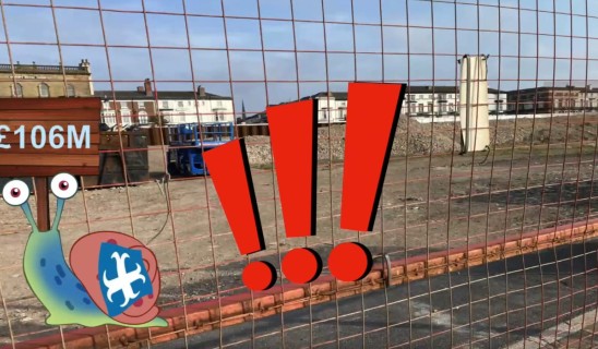 Cartoon snail with blue shell and red exclamation marks over a construction site behind a wire fence