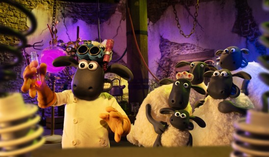 Lab scene with a black sheep wearing goggles and a white coat, holding a pink liquid in a test tube, surrounded by several other sheep characters in a dim, colorful lab setting.