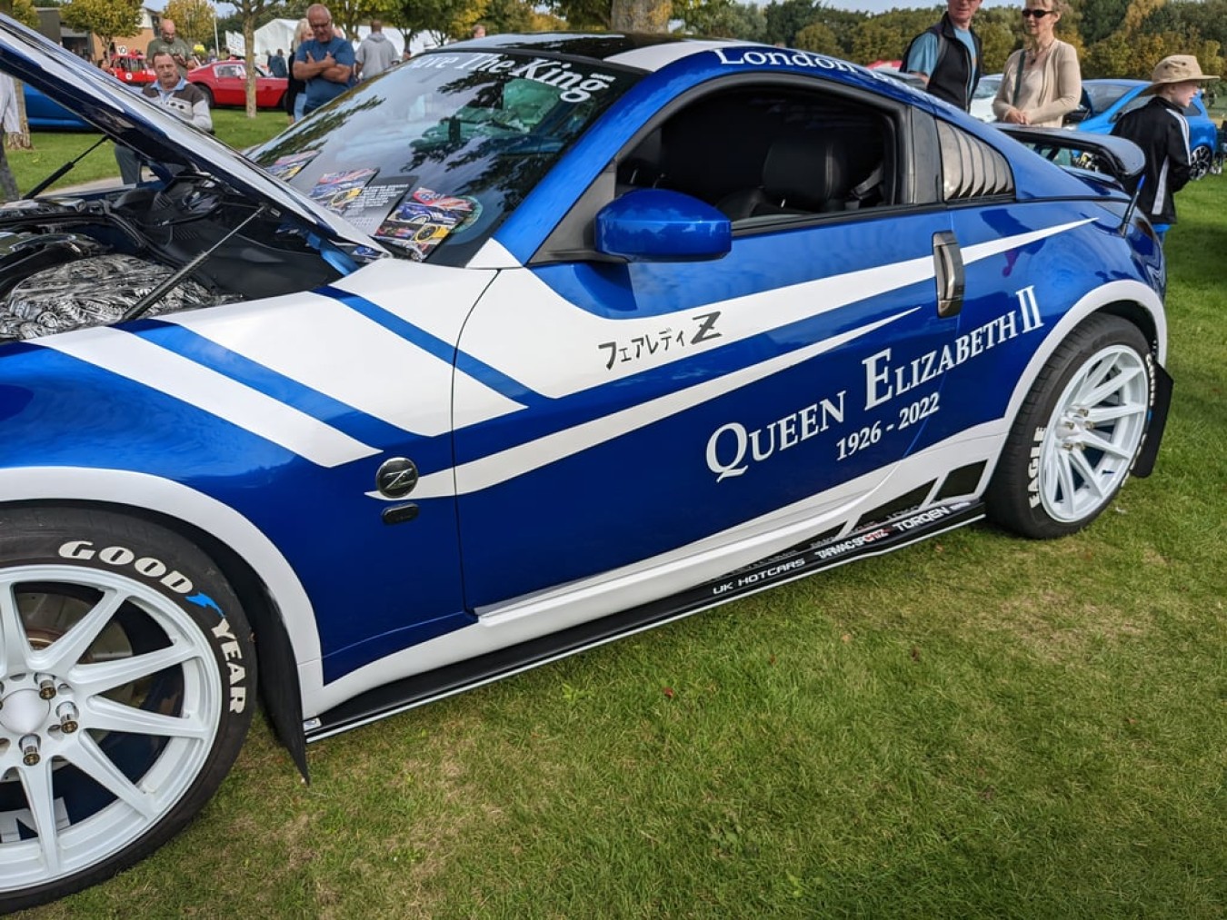 a blue and white car parked on grass